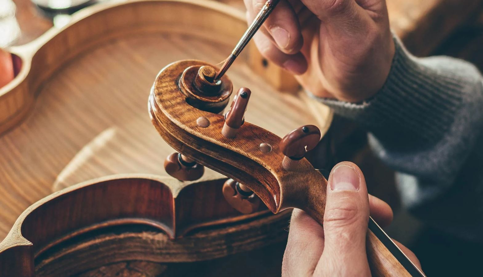 Restored sheet music illuminated on a desk beside scattered manuscript fragments